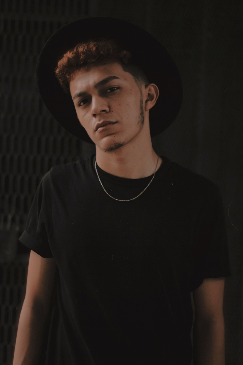 Man in Black Crew Neck T-shirt Wearing Black Hat